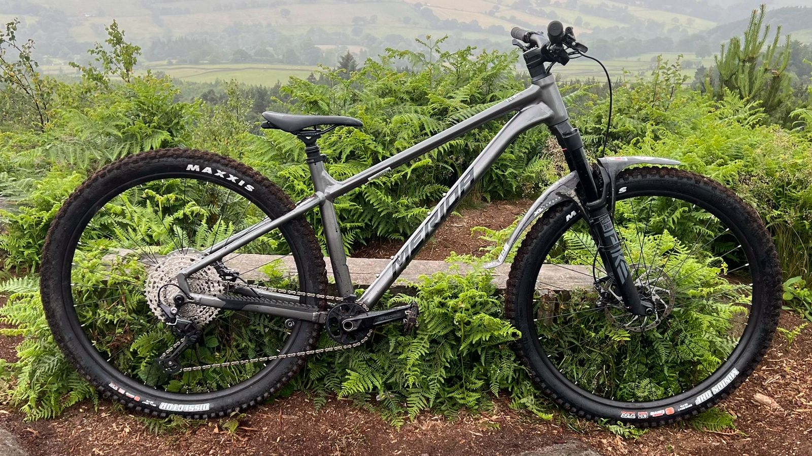A Merida Big Trail 600 seen side on on a hill top